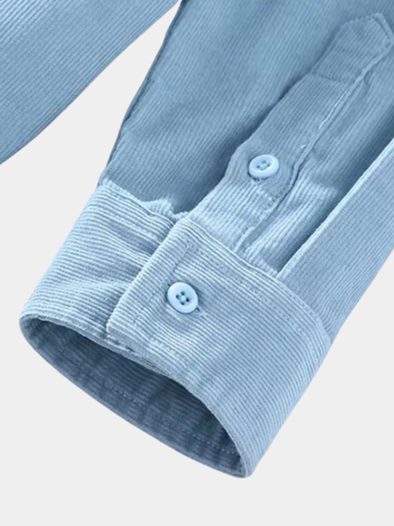 Close-up of light blue corduroy shirt button cuff