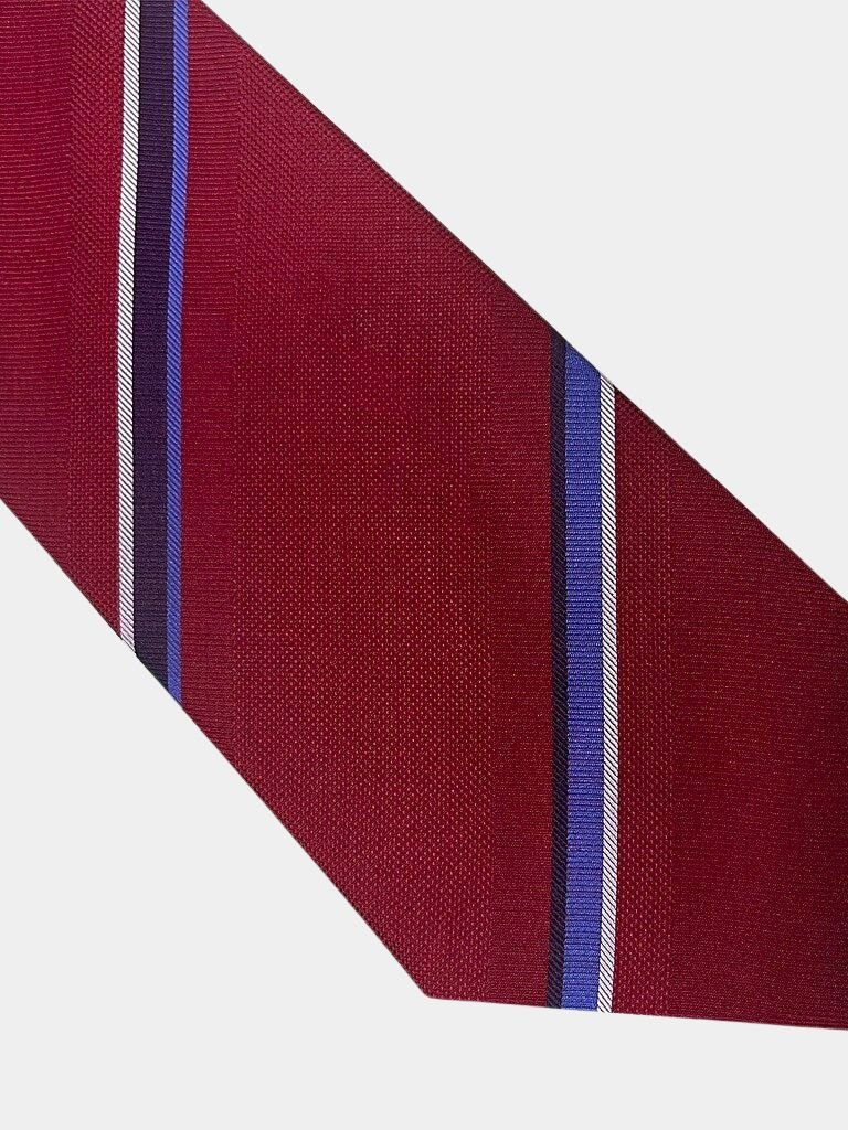 Close-up of the red tie's diagonal stripe pattern