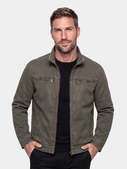 Man wearing the Valmont olive field jacket by Cross & Crown over a black tee