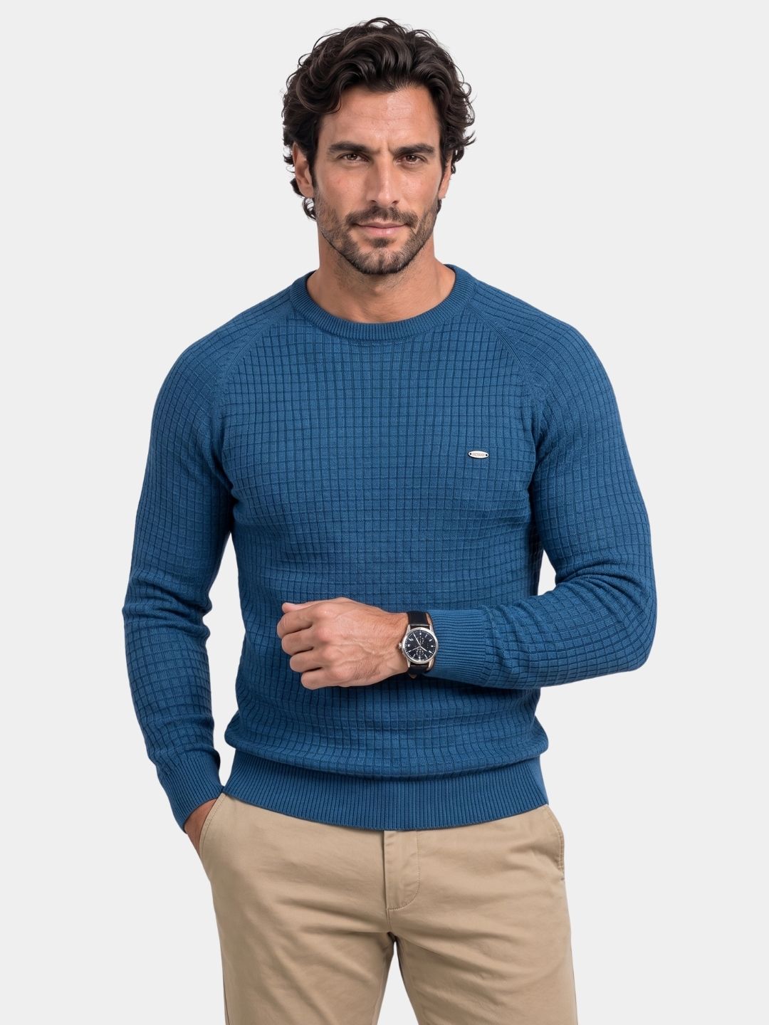 Man wearing a blue waffle-knit crew neck jumper sweater