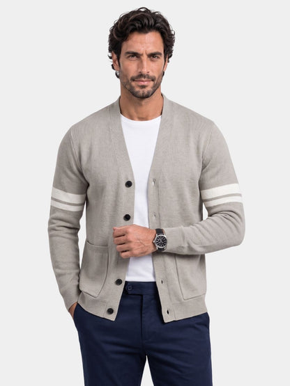 Man wearing the light gray Duke cardigan with contrast sleeve stripes