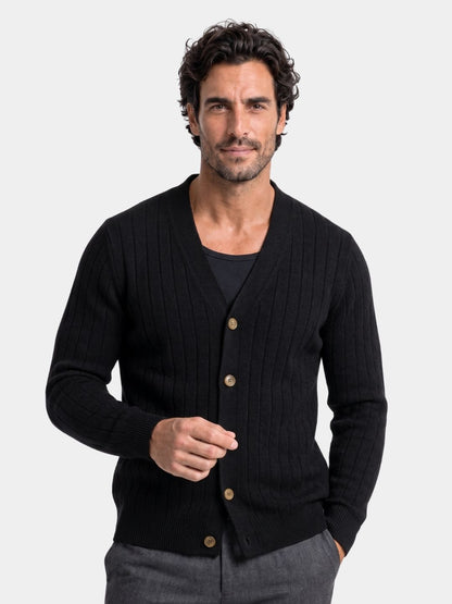 Man wearing the black ribbed knit cardigan buttoned to the collar