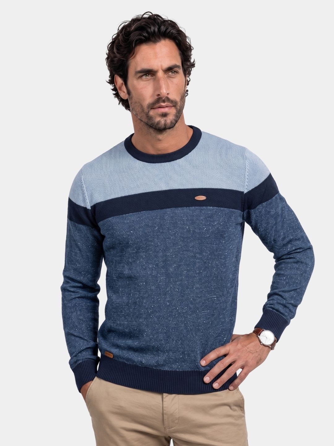 Man wearing the navy colorblock crew neck sweater with a chest stripe