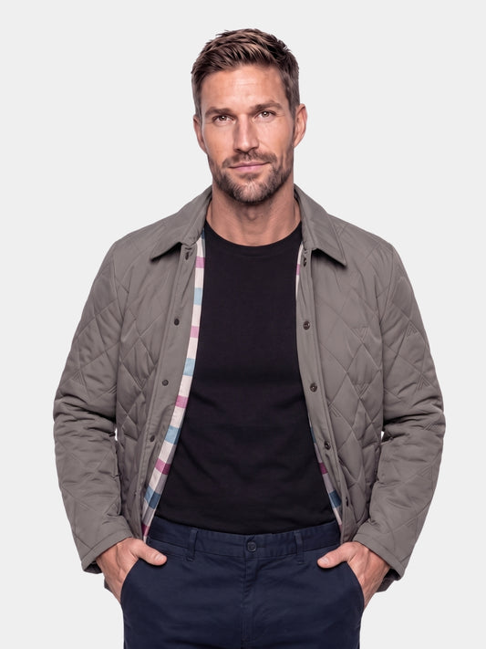 Man wearing a gray quilted chore jacket, Cross & Crown