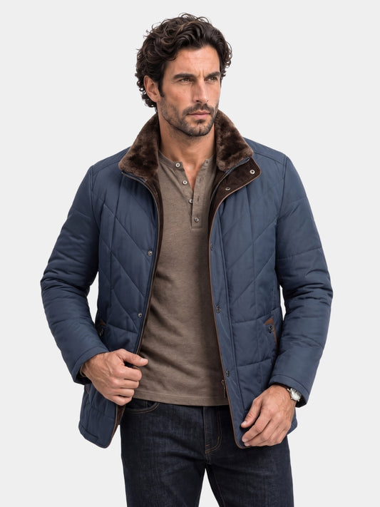 Man wearing navy quilted jacket with fur-trim collar Cross & Crown