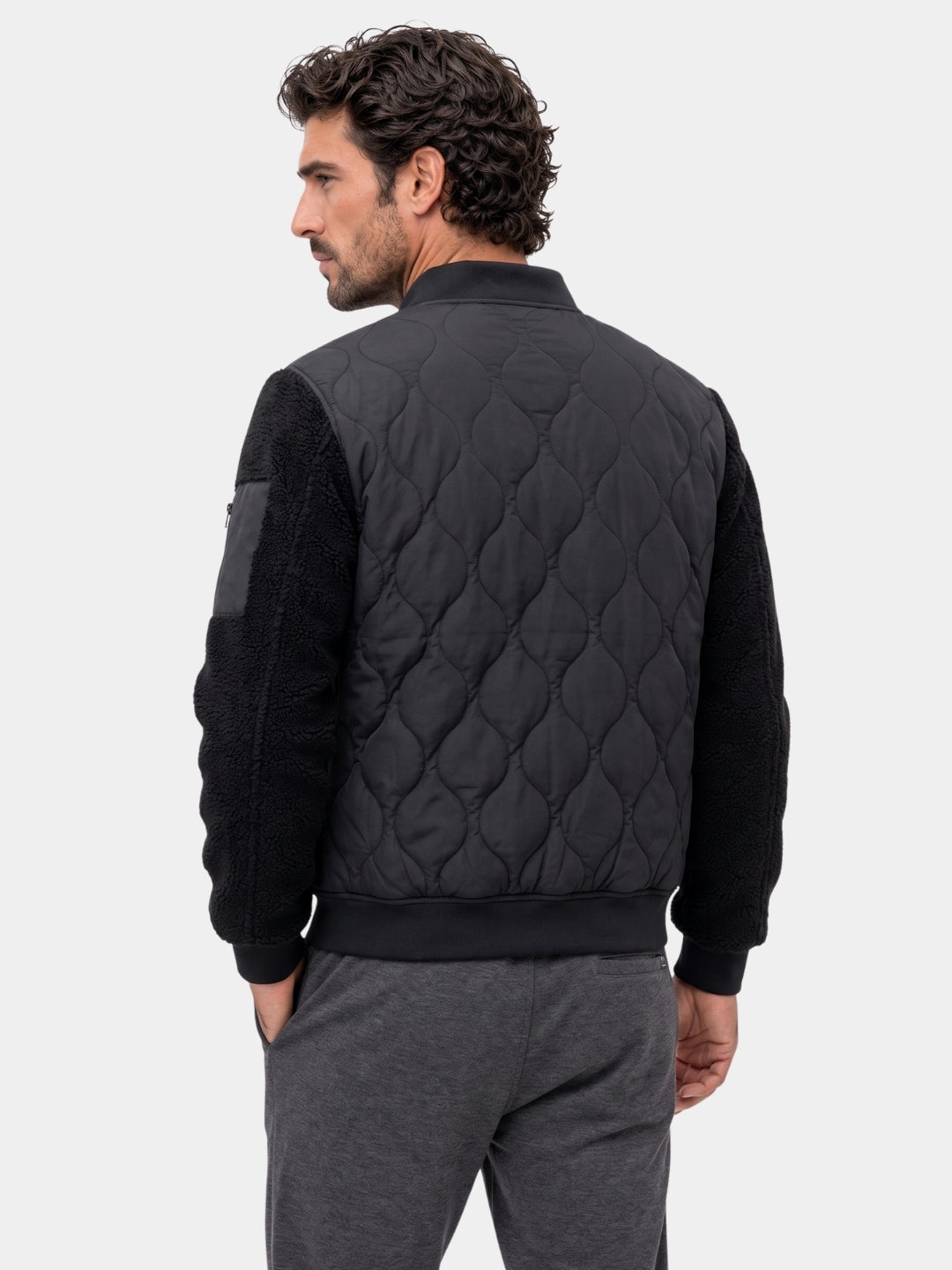 Back view of the black quilted bomber jacket with sherpa sleeves