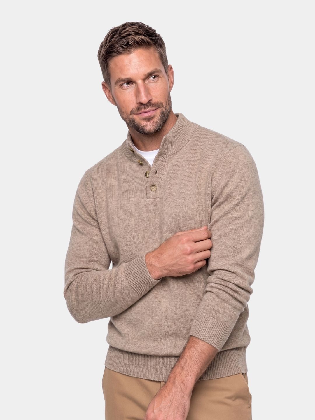 Man wearing a tan button mock neck cashmere sweater