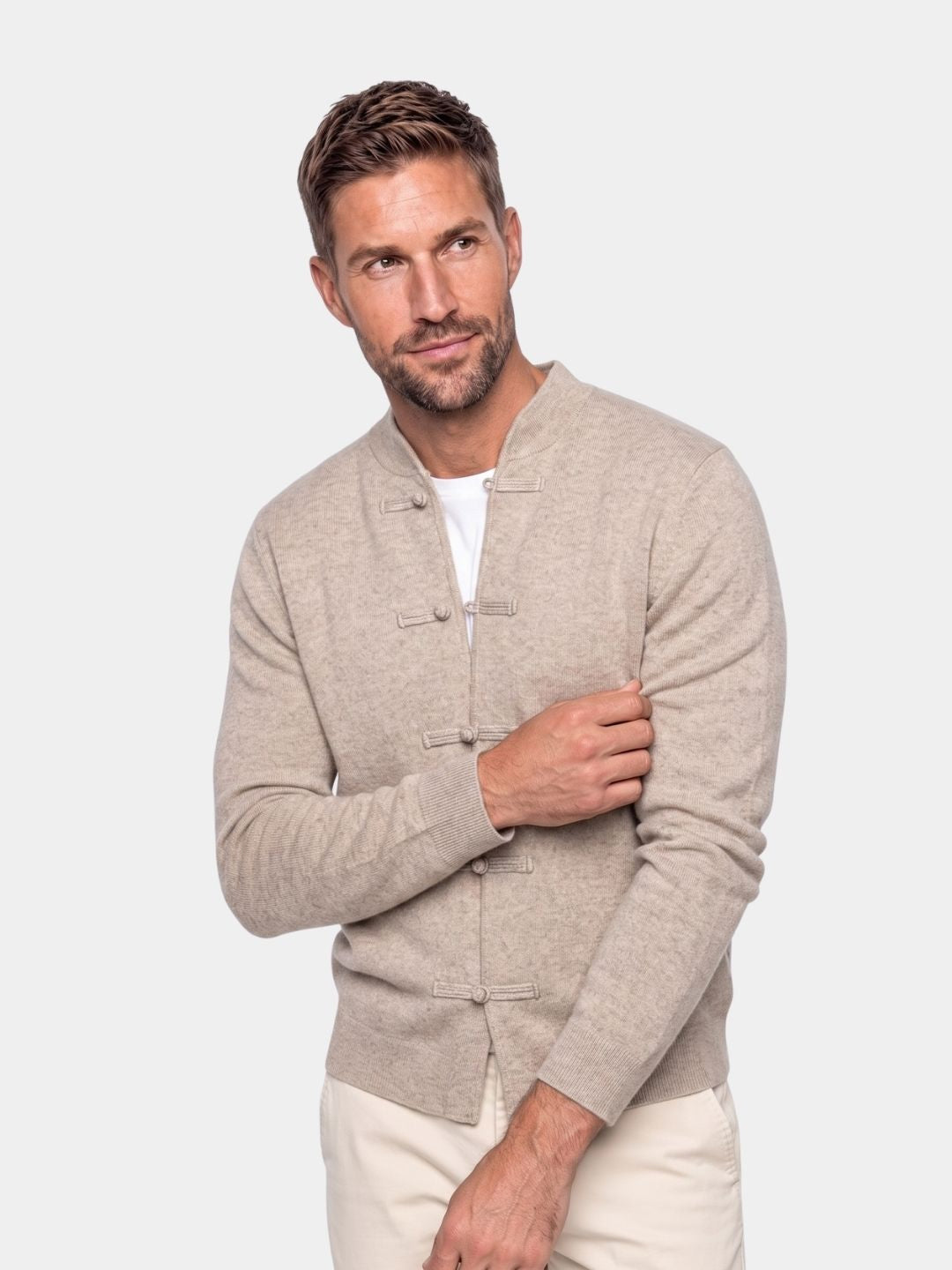 Man wearing the beige cashmere mandarin collar cardigan with frog buttons