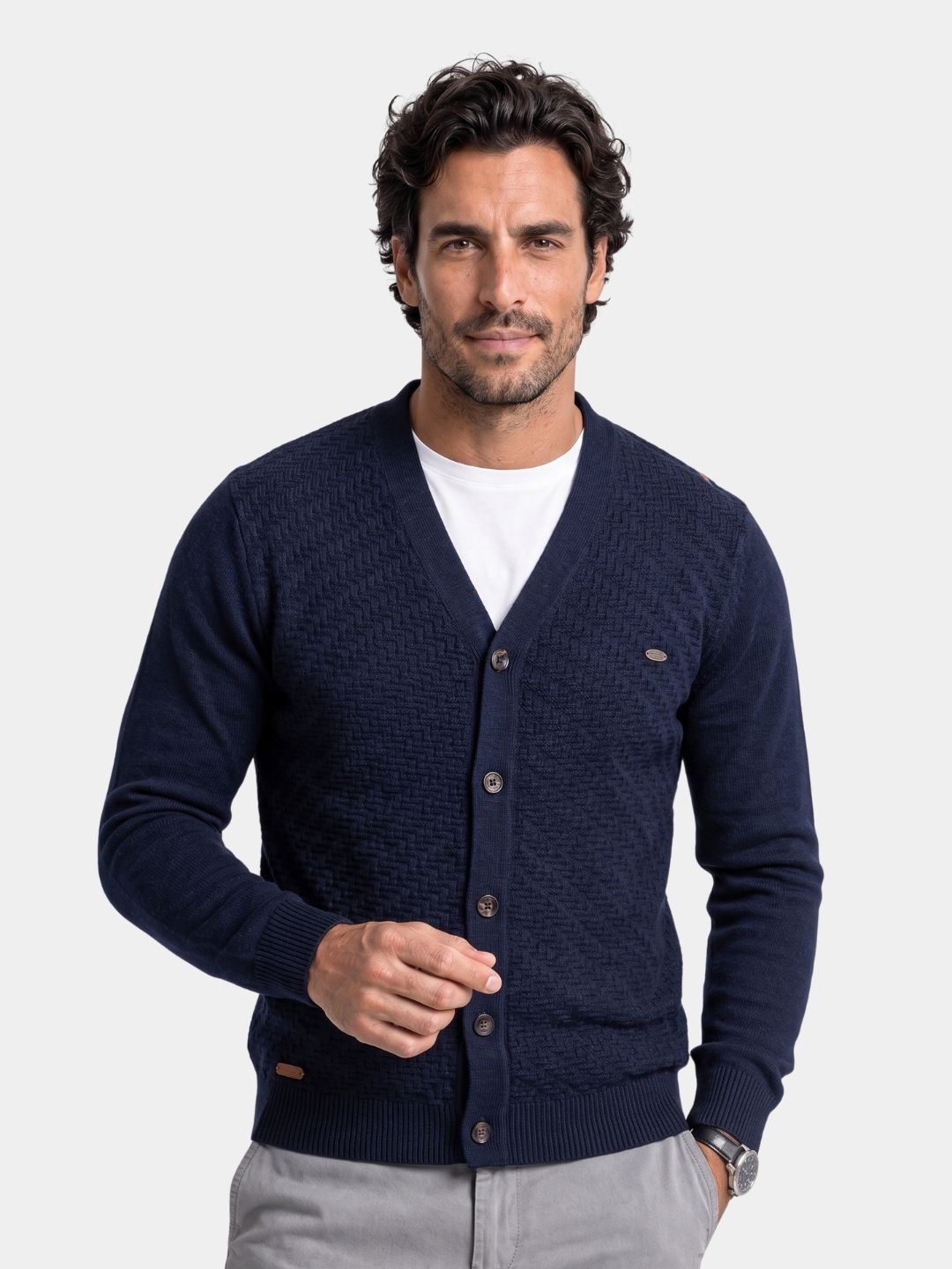 Cross & Crown man wearing the navy textured V-neck cardigan over a white tee