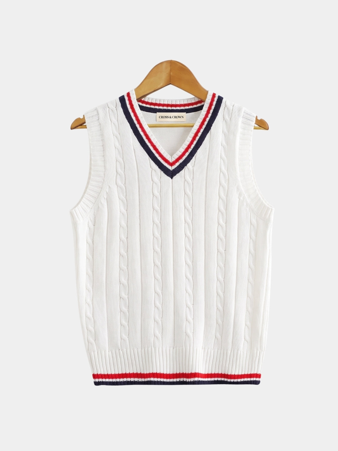 Front view of the white cable-knit cricket vest with striped trim.