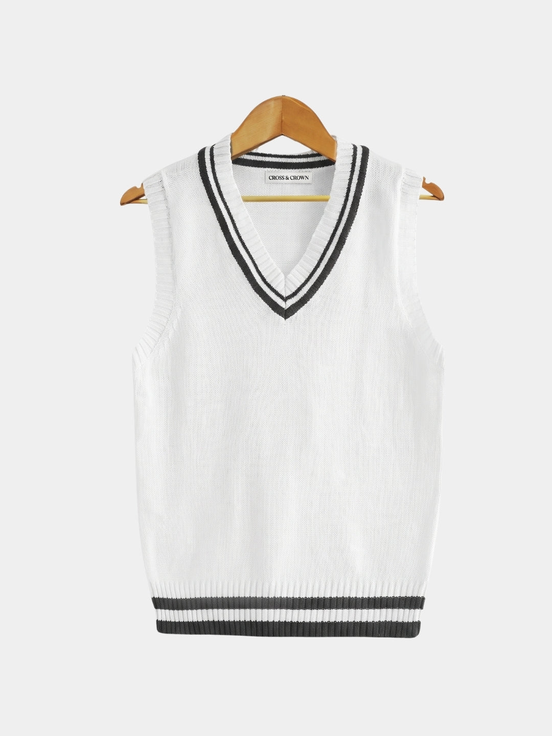 Front view of the white cable-knit cricket vest with black trim.
