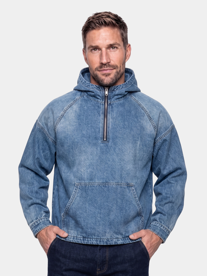 Cross & Crown man wearing the blue denim quarter-zip hoodie with hands in the front pocket