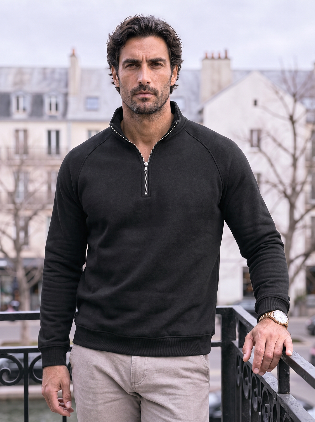Man wearing the black quarter-zip pullover on a city street