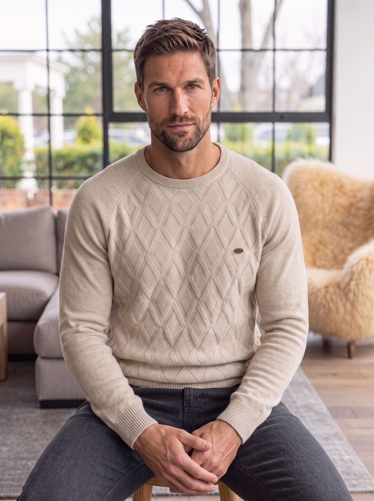 Beige diamond-knit crew neck sweater on a hanger