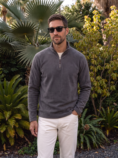 Man wearing the gray pullover outdoors