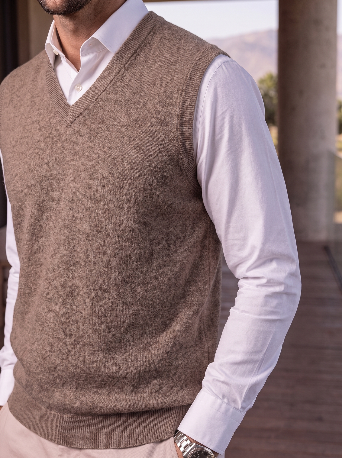 Close-up of the taupe merino wool V-neck vest on a model.