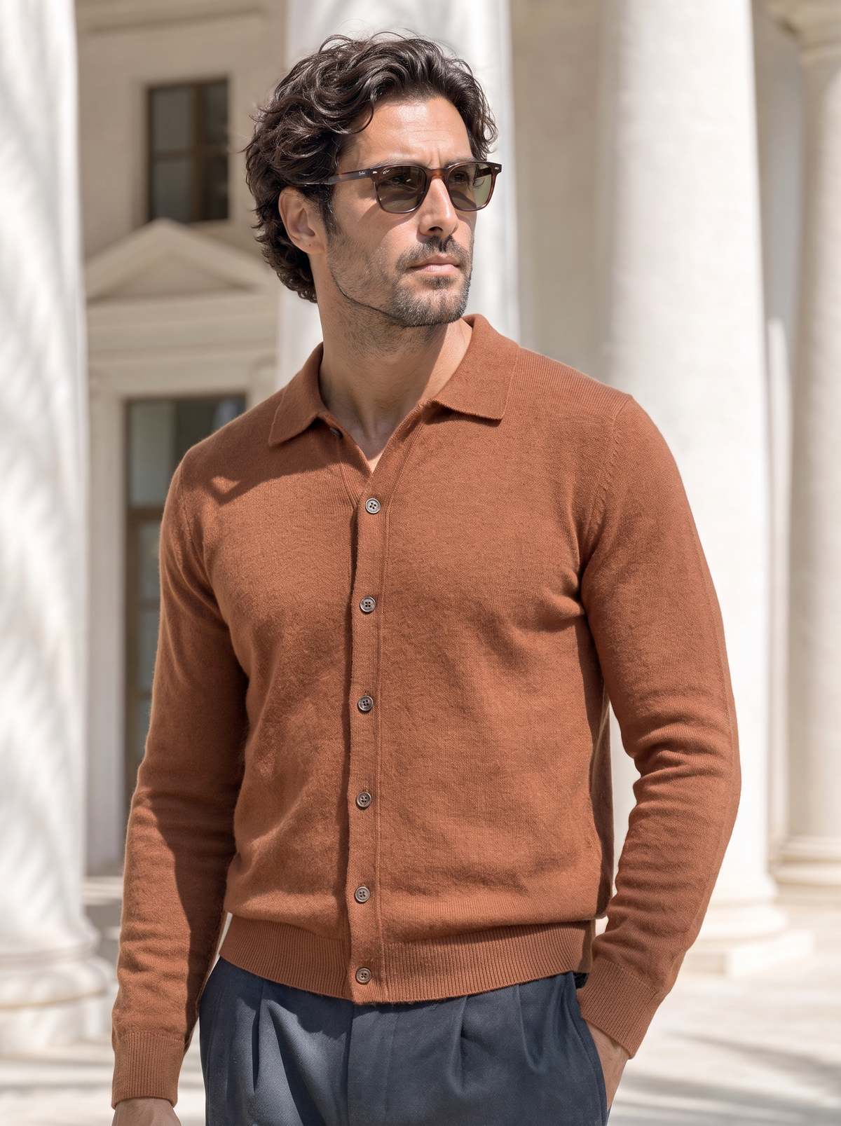 Man in sunglasses wearing the rust cashmere polo collar cardigan outdoors