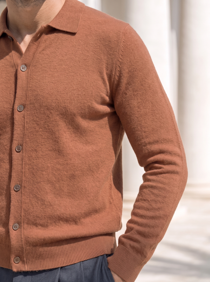 Close-up of the polo collar and button placket on the rust cardigan
