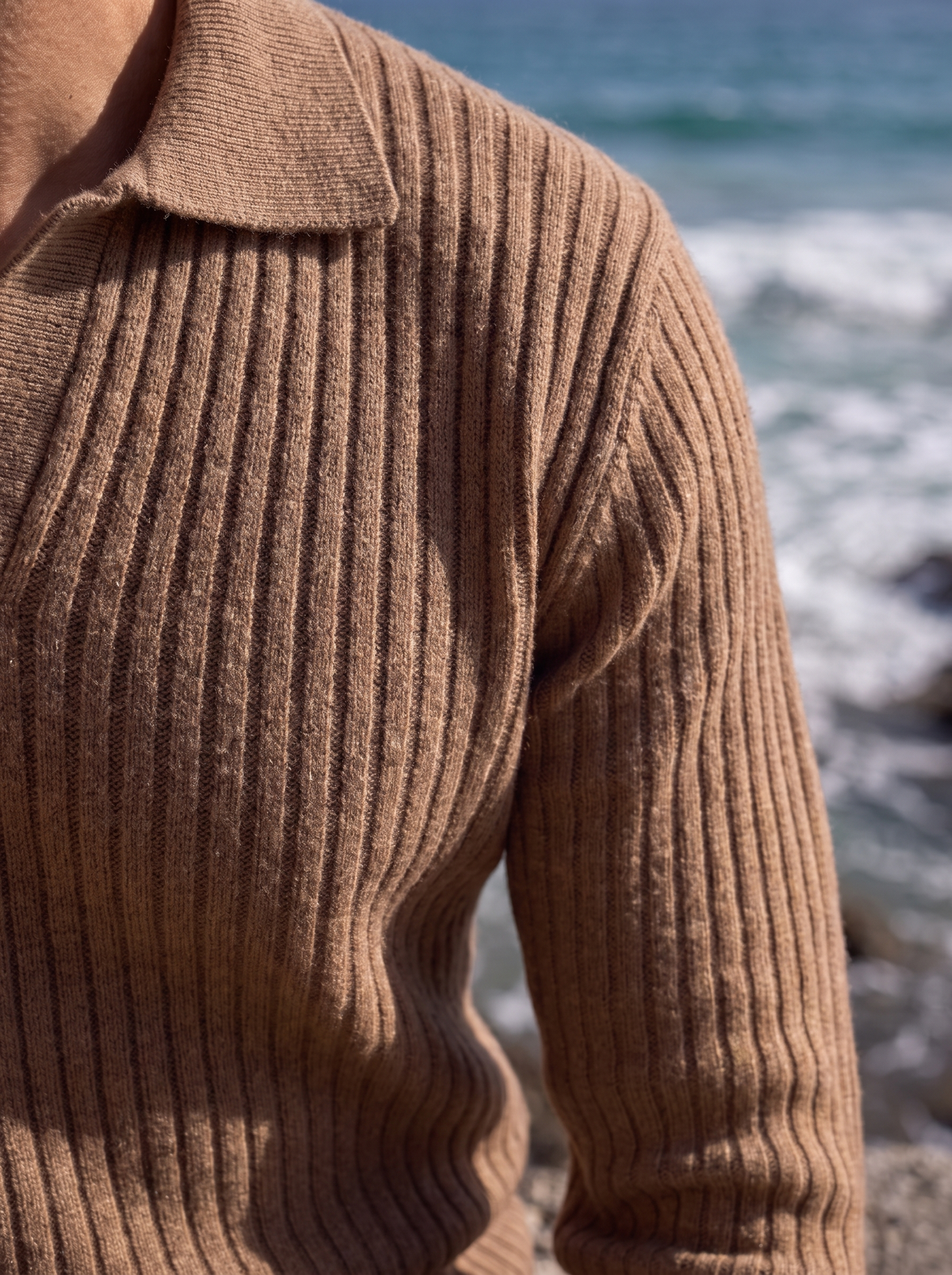 Close-up of the ribbed knit texture and open collar