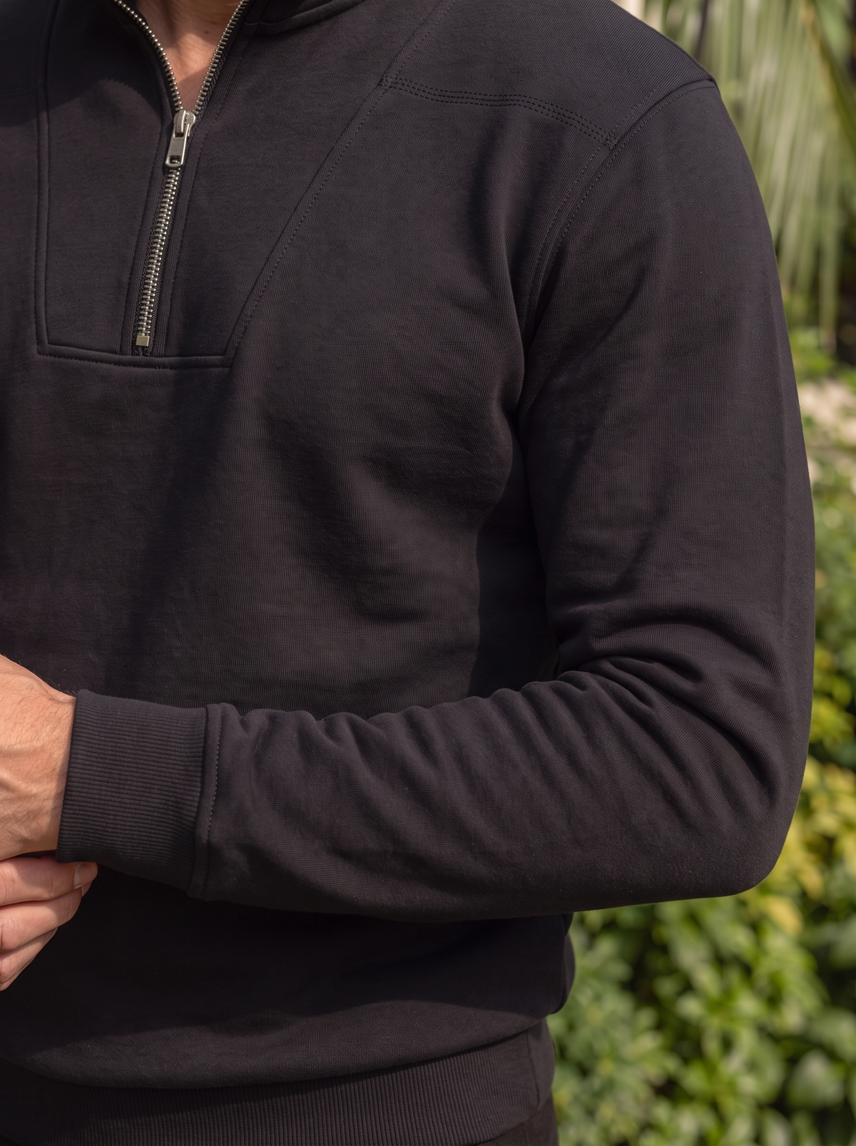 Close-up of the zip collar on the black sweatshirt