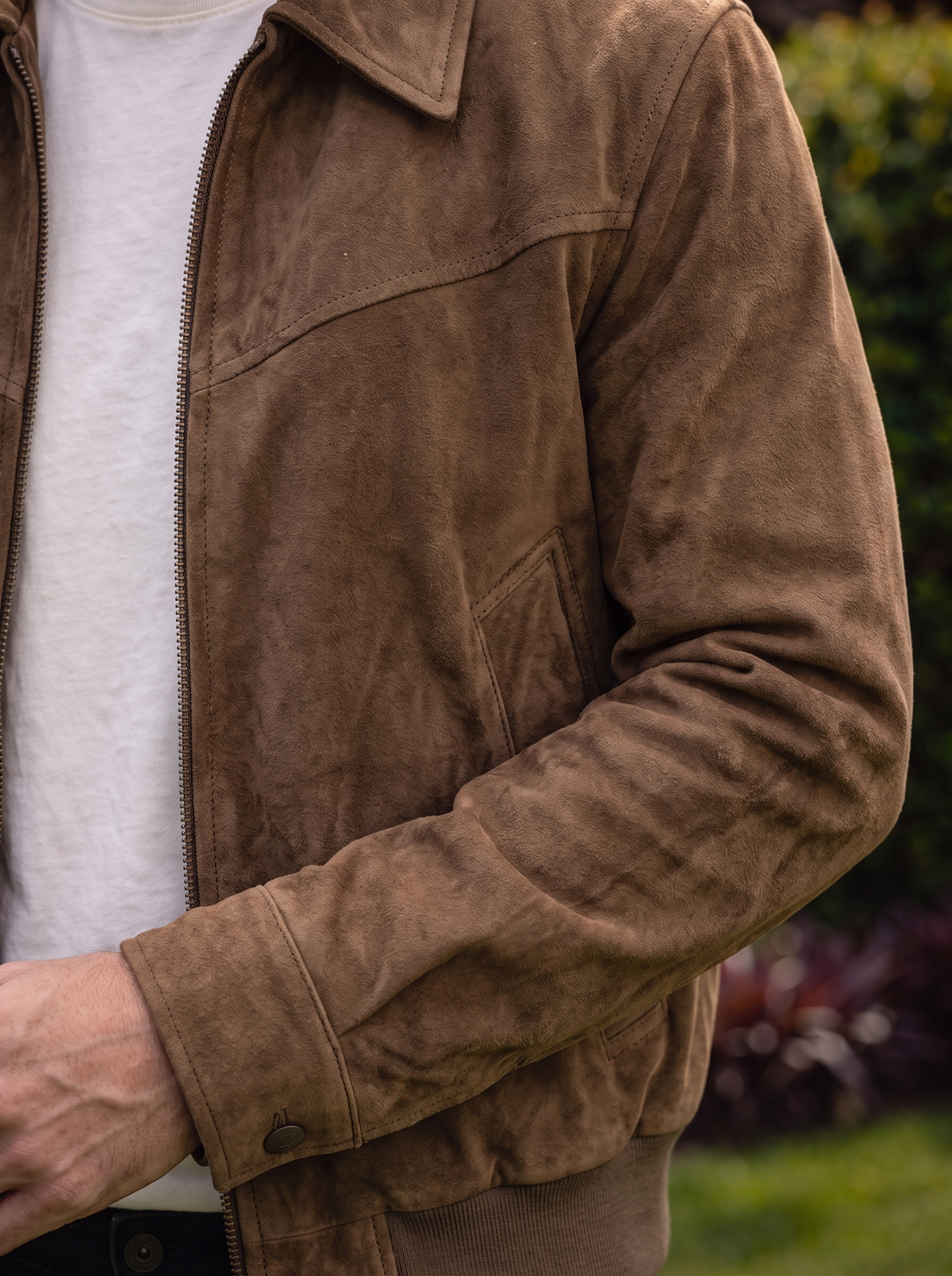 Close-up of the collar and zipper on the suede jacket.