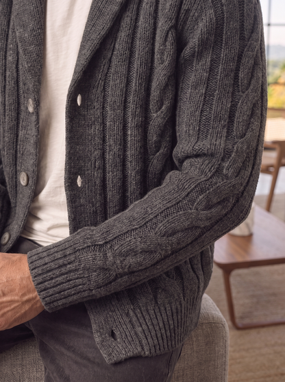 Close-up of the cable knit texture and button placket in charcoal