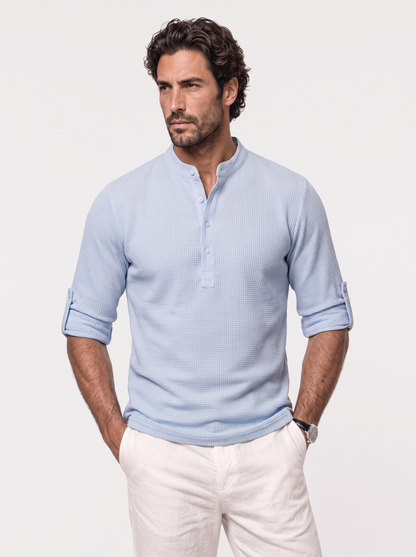 Man wearing a blue waffle knit henley popover shirt, Cross & Crown
